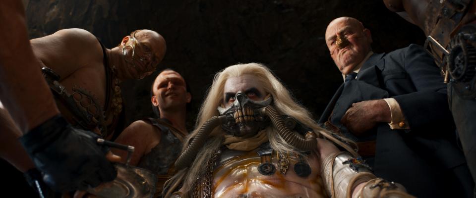 Immortan Joe (Lachy Hulme, center) rules the Citadel alongside his sons Rictus Erectus (Nathan Jones) and Scrotus (Josh Helman) as well as right-hand man the People Eater (John Howard).