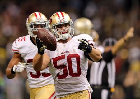 Nov 9, 2014; New Orleans, LA, USA; San Francisco 49ers inside linebacker Chris Borland (50) celebrates after a fumbled by New Orleans Saints quarterback Drew Brees (not pictured) in overtime at Mercedes-Benz Superdome. The 49ers won 27-24. Mandatory Credit: Chuck Cook-USA TODAY Sports