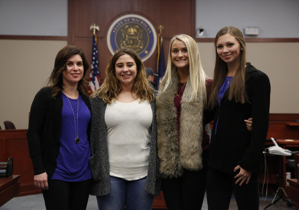 Nassar survivors&nbsp;Larissa Boyce, Alexis Alvarado, Christine Harrison and Jessica Smith (left to right) pose for a picture in court after the Nov. 22, 2017, hearing&nbsp;in which Nassar pleaded guilty to criminal sexual conduct. (Photo: JEFF KOWALSKY/AFP/Getty Images)