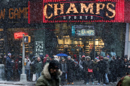 People walk around Times Square as a cold weather front hits the region, in Manhattan, New York, U.S., December 30, 2017. REUTERS/Eduardo Munoz