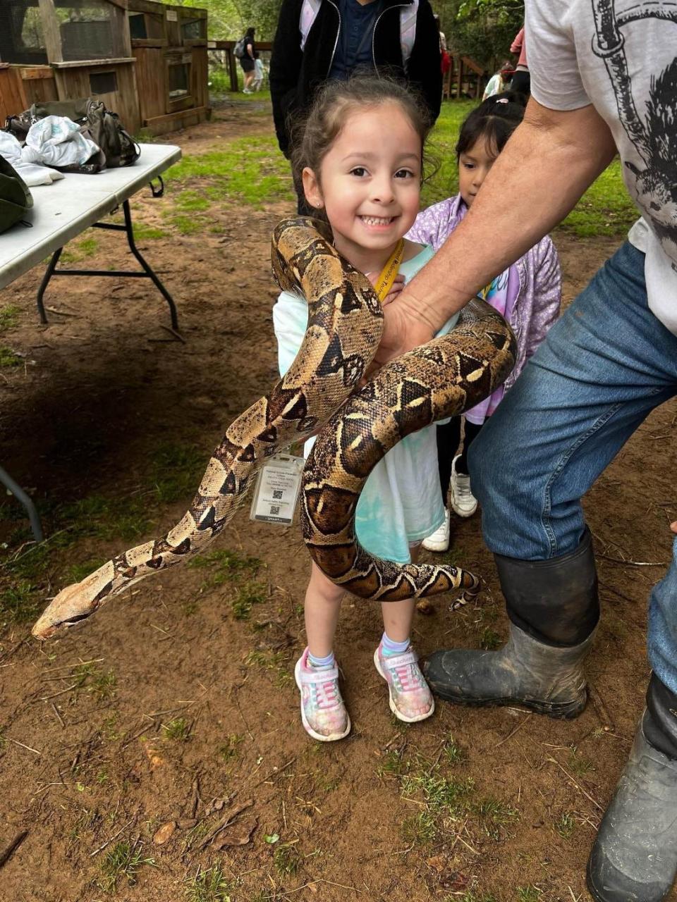 Diana Limon, Victoria Limon's daughter, had her picture taken with a boa constrictor at the Capital of Texas Zoo during the March 22 field trip before the bus crash that afternoon.
