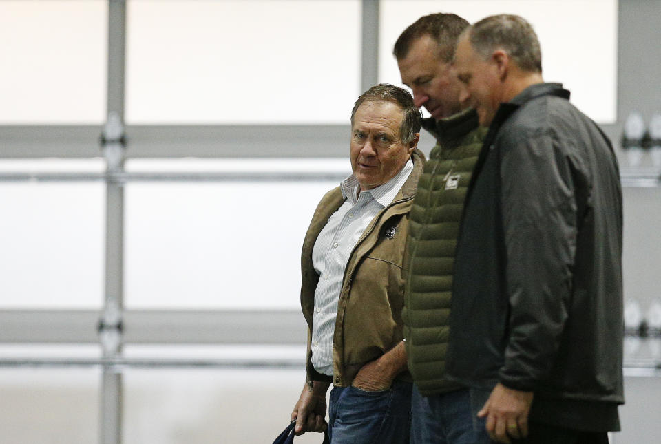 New England Patriots coach Bill Belichick, left, and former Arkansas coach Bret Bielema, center, are now officially colleagues. (AP Photo)