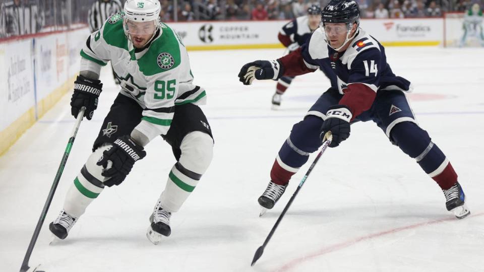 <div>DENVER, COLORADO - APRIL 07: Craig Smith #15 of the Dallas Stars advances the puck against Chris Wagner #14 of the Colorado Avalanche during the first period at Ball Arena on April 07, 2024 in Denver, Colorado. (Photo by Matthew Stockman/Getty Images)</div>