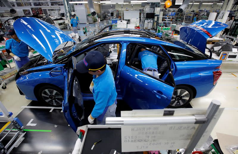 FILE PHOTO: Employees of Toyota Motor Corp. work on an assembly line