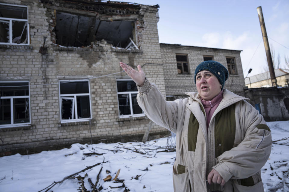 Valentyna Mozgova, 55, lab medic gestures as she talks at a hospital which was damaged by Russian shelling in Krasnohorivka, Ukraine, Sunday, Feb. 19, 2023. (AP Photo/Evgeniy Maloletka)