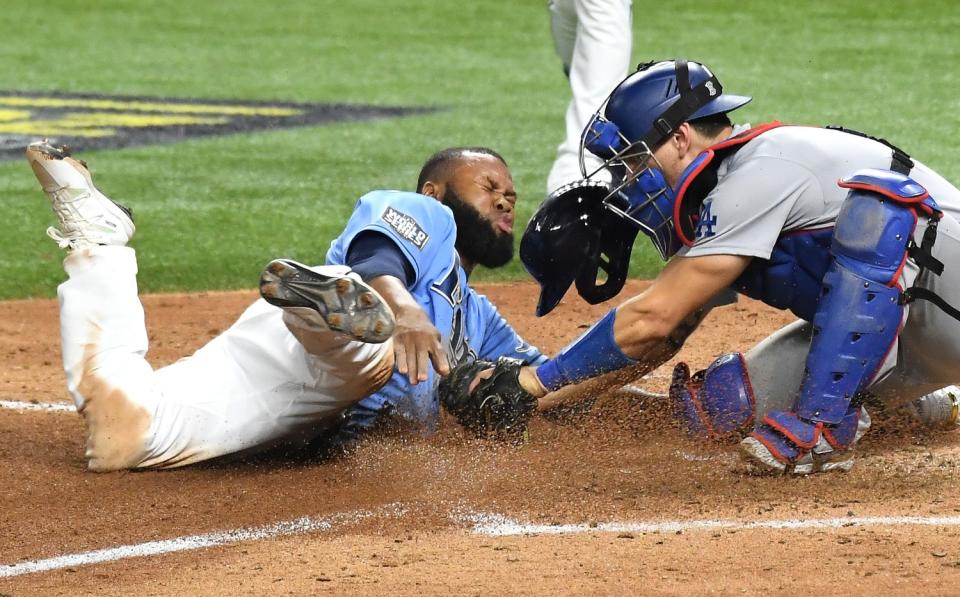 Dodgers catcher Austin Barnes tags out Rays' Manuel Margot sliding home