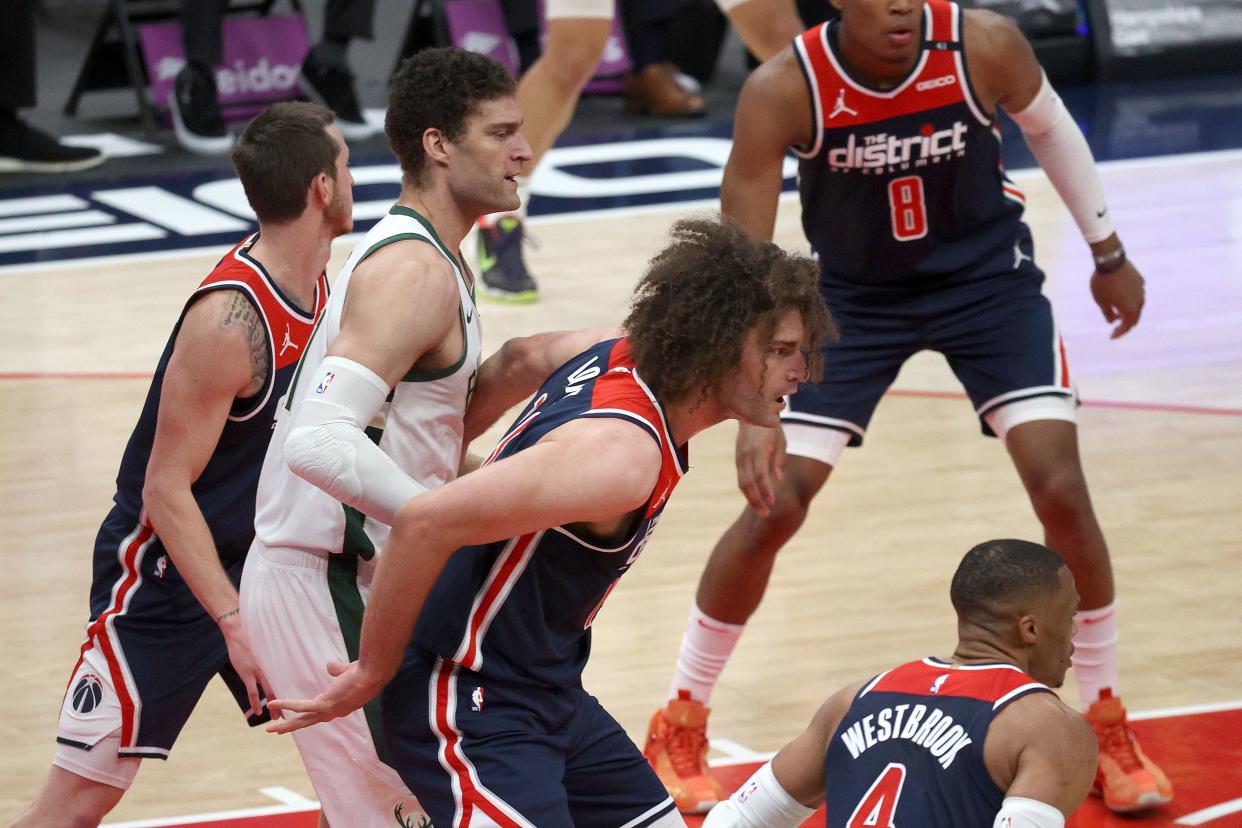 Buicks center Brook Lopez battles in the paint with his twin brother Robin Lopez of the Wizards.