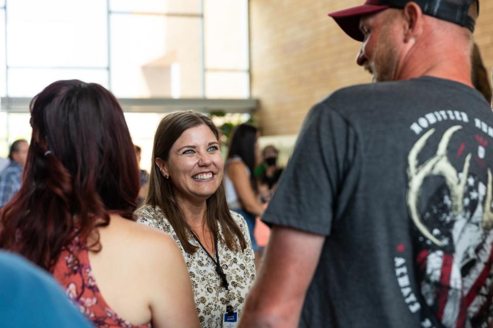 Tyler Larsen, right, and his wife Kasi Larsen, left, talk to Jenn Wierschem, their transplant social worker, at an event held to celebrate the milestone of 600 lifesaving transplants by the Intermountain heart transplant team at the Intermountain Medical Center in Murray on Tuesday, July 18, 2023. | Megan Nielsen, Deseret News