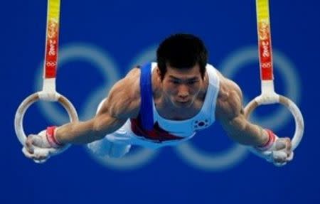 FILE PHOTO - Yang Tae-young of South Korea practises on the rings during an artistic gymnastics training session at the National Indoor Stadium ahead of the Beijing 2008 Olympic Games August 6, 2008. REUTERS/Mike Blake/File photo