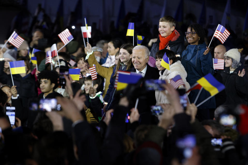 President Joe Biden poses with children after his speech at the Royal Castle after meeting with Polish President Andrzej Duda in Warsaw, Poland, Tuesday, Feb. 21, 2023. (AP Photo/Michal Dyjuk)