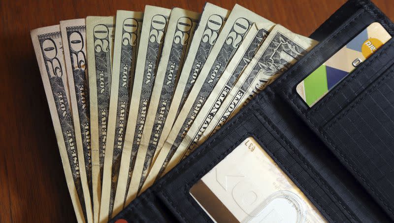In this June 15, 2018, file photo, cash is fanned out from a wallet in North Andover, Mass. Despite evidence of people cheating others, studies show most still act honestly when they find money.