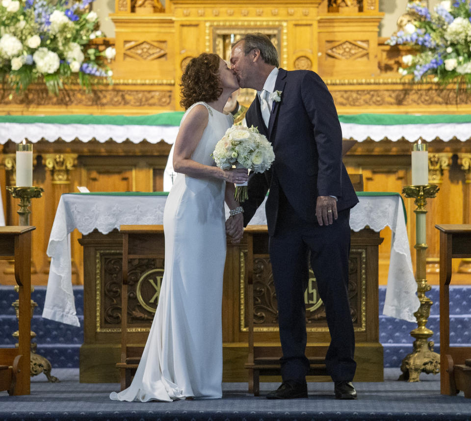 Associated Press staff photographer Gerald Herbert kisses his new bride, Lucy Sikes, after getting married at Mater Dolorosa Catholic Church in New Orleans, before Tropical Storm Barry makes landfall in Louisiana, Friday, July 12, 2019. The wedding was scheduled for Saturday, but with the impending storm, the couple moved the nuptials to Friday evening. (David Grunfeld/The Advocate via AP)