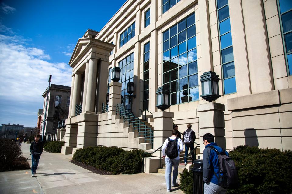 University of Iowa students walk on campus, Thursday, March 12, 2020, outside the Tippie College of Business in Iowa City, Iowa.