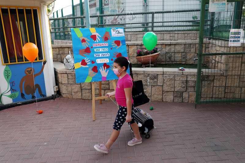 A pupil, wearing protective face mask, arrives at school as Israel reopens first to fourth grades, continuing to ease a second nationwide coronavirus disease (COVID-19) lockdown, at a school in Rehovot