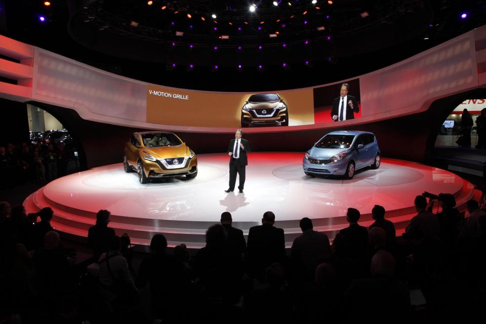 FILE - In this Tuesday, Jan. 15, 2013, file photo, Dr. Andy Palmer, Executive Vice President, Nissan Motor Co., talks about the Nissan Resonance, left, and Versa Note, right, at media previews for the North American International Auto Show in Detroit. This year, at least 50 new vehicles will make their debut. (AP Photo/Paul Sancya)