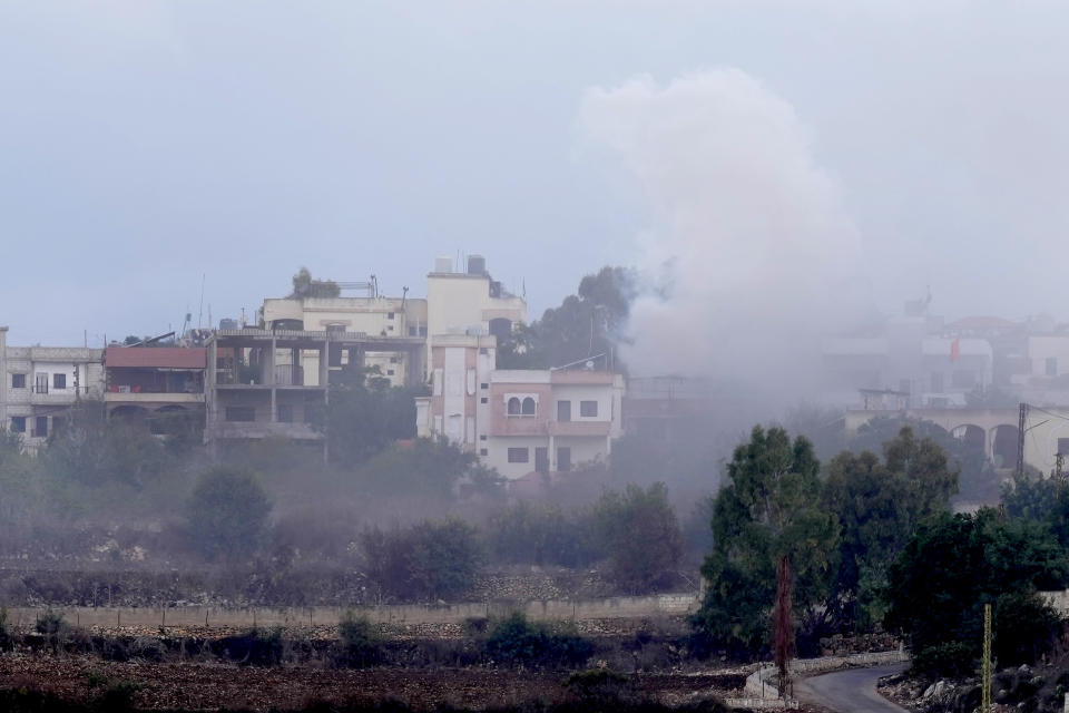 Smoke rises from artillery shell that hit the houses of Aita al-Shaab a Lebanese border village with Israel, south Lebanon, Sunday, Oct. 15, 2023. Shelling and clashes near the Lebanese southern border village of Aita al-Shaab and northern Israeli border town of Shtula marks an ongoing escalation in clashes between Hezbollah and the Israeli military. (AP Photo/Hussein Malla)