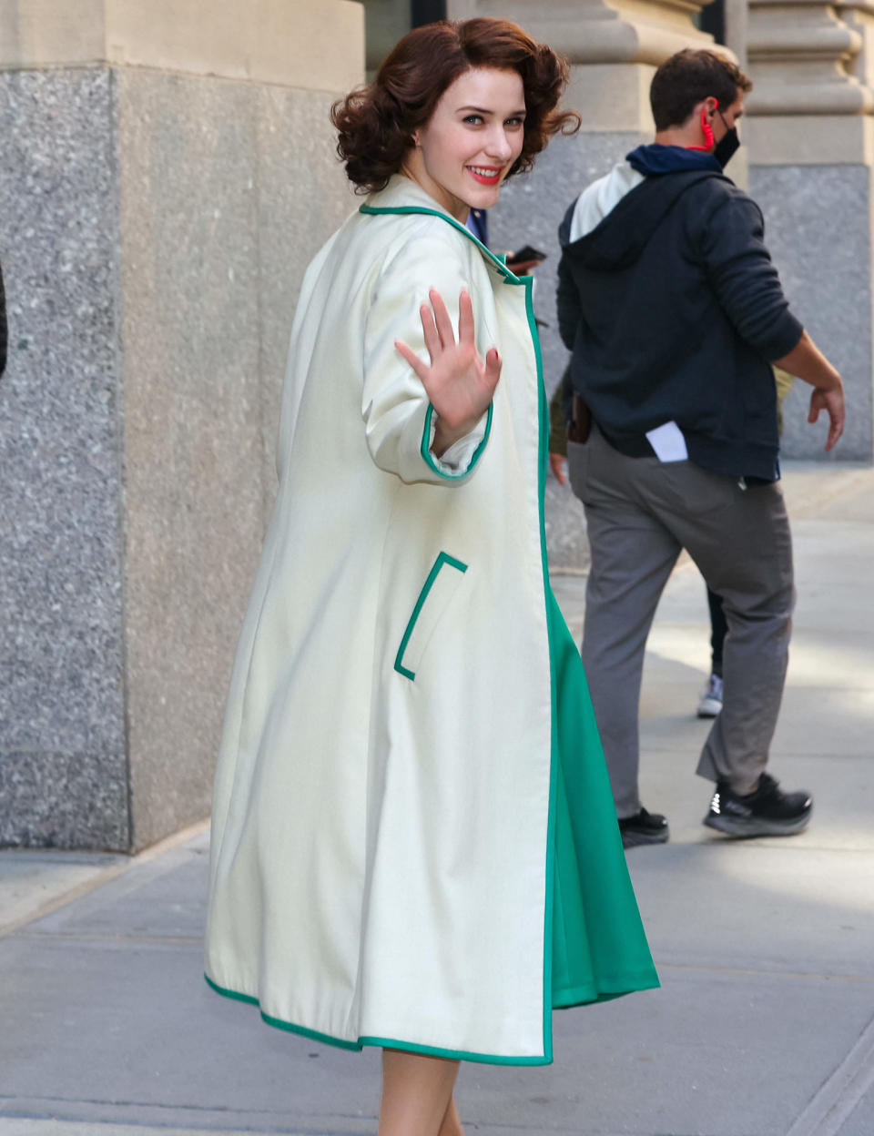 <p>Rachel Brosnahan waves to the cameras on the New York City set of <em>The Marvelous Mrs. Maisel </em>on Sept. 29.</p>