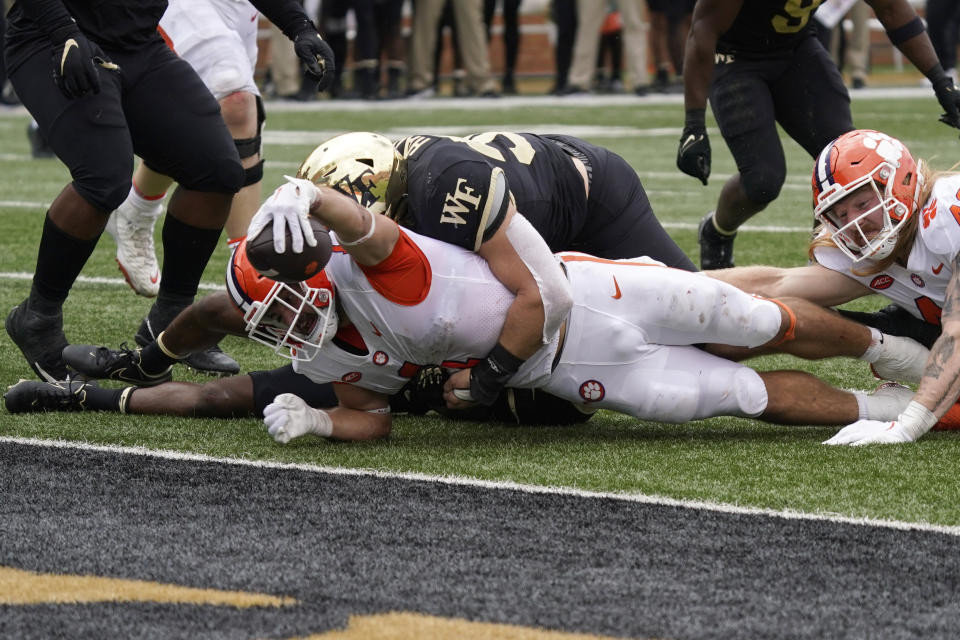 Clemson running back Will Shipley (1) reaches the ball over the goal line for a touchdown as Wake Forest linebacker Dylan Hazen (50) holds on during the second half of an NCAA college football game in Winston-Salem, N.C., Saturday, Sept. 24, 2022. (AP Photo/Chuck Burton)