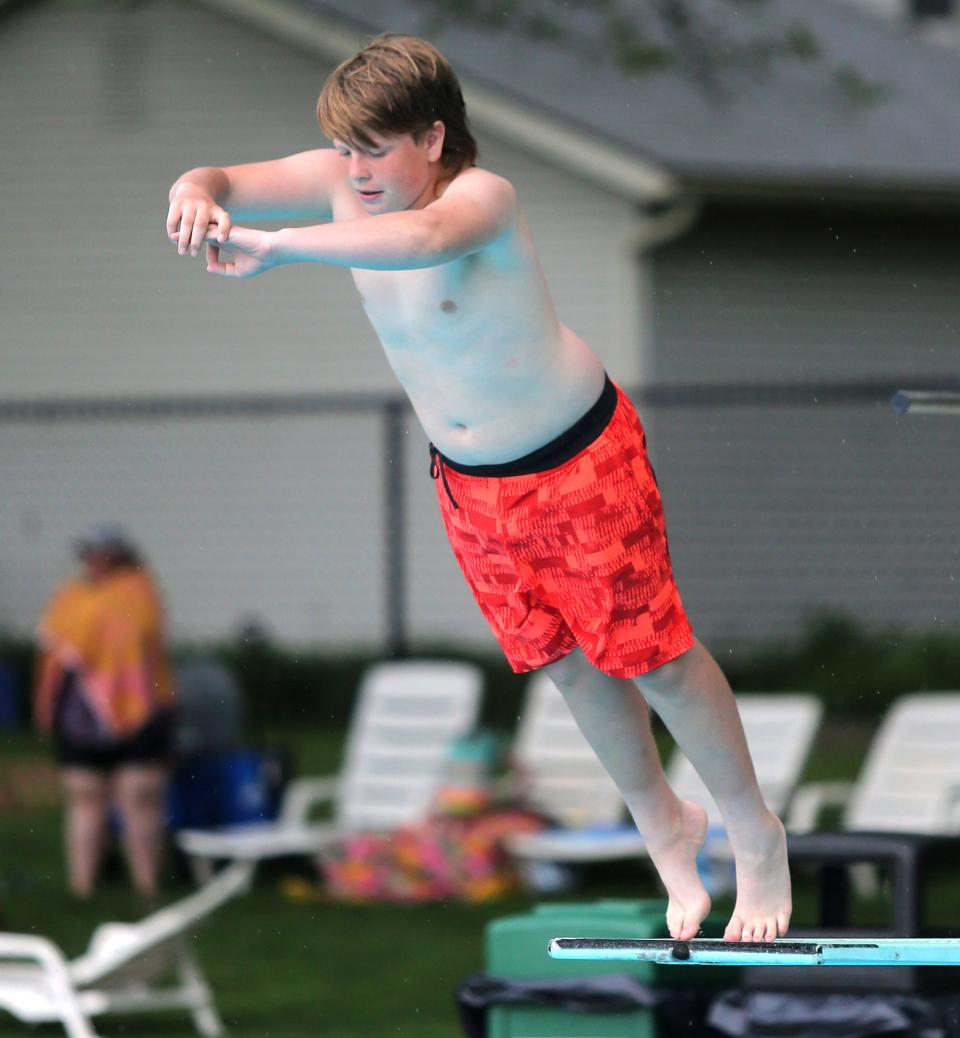 Aidan Kavanagh goes off the diving board at Dogwood Pool in North Canton on Wednesday. Dogwood is one of the Stark County locations slated to get funding in Ohio's capital budget.
