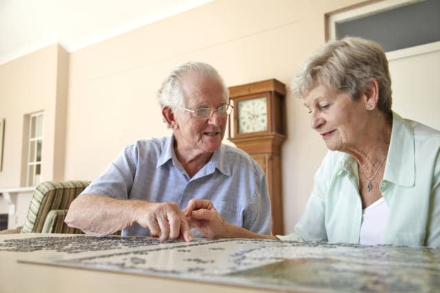 Elderly couple doing jigsaw puzzle