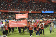 Sunrisers Hyderabad team members gestures towards the crowd after their team won the match against Punjab Kings in Indian Premier League cricket tournament in Hyderabad, India, Sunday, May19, 2024. (AP Photo/Mahesh Kumar A.)