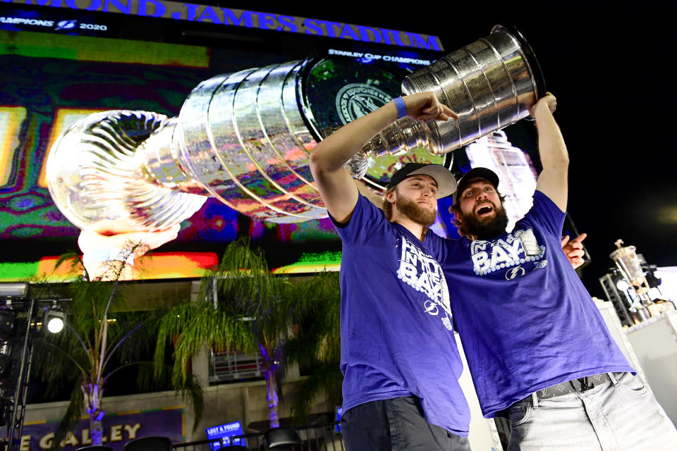 TAMPA, FLORIDA - SEPTEMBER 30: Alexander Volkov #92 and Nikita Kucherov #86 of the Tampa Bay Lightning hold the Stanley Cup above their head during the 2020 Stanley Cup Champion rally on September 30, 2020 in Tampa, Florida. (Photo by Douglas P. DeFelice/Getty Images)