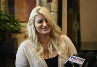 Chelsea Romo reacts as she recounts some of the details of the the Las Vegas Shooting at a news conference, Thursday, Oct. 3, 2019, in San Diego. Romo lost her left eye in the Las Vegas shooting. Two years after a shooter rained gunfire on country music fans from a high-rise Las Vegas hotel, MGM Resorts International reached a settlement that could pay up to $800 million to families of the 58 people who died and hundreds of others who were injured, attorneys announced Thursday. (AP Photo/Denis Poroy)