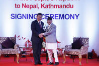 Chinese President Xi Jinping, left, and Nepalese Prime Minister Khadga Prasad Oli greet during their bilateral meeting in Kathmandu, Nepal, Sunday, Oct. 13, 2019. Xi on Saturday became the first Chinese president in more than two decades to visit Nepal, where he's expected to sign agreements on some infrastructure projects. (Bikash Dware/The Rising Nepal via AP)