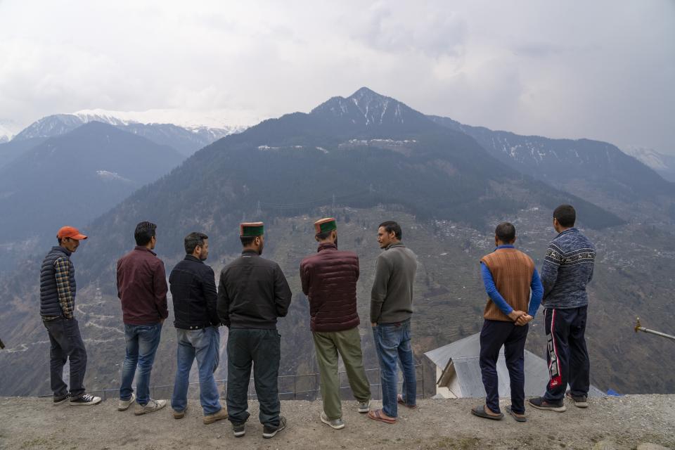 Activists exchange information with the residents of Kandar, a remote village that had to be resettled after rockslides damaged houses in the original village in the Kinnaur district of the Himalayan state of Himachal Pradesh, India, Sunday, March 12, 2023. In past years resentment against the hydroelectric dams has grown, mirroring concerns across the environmentally sensitive Himalayas about building dams with inadequate assessments. (AP Photo/Ashwini Bhatia)