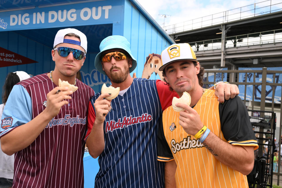 (L-R) Jackson Olson, Ryan Cox and David Meadows of the Savannah Bananas enjoy Uncrustables at the 2024 Little League Baseball® World Series Game Schedule at Little League International Complex on August 20, 2024 in South Williamsport, Pennsylvania.