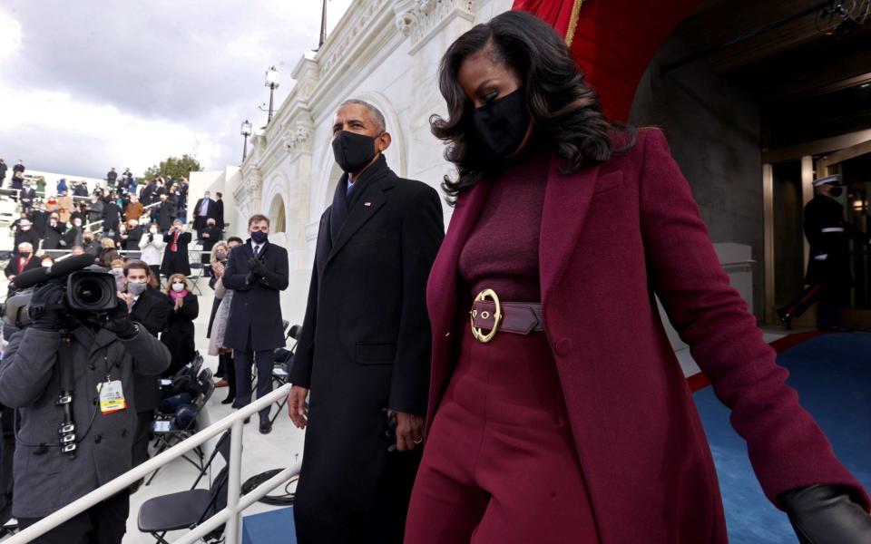 Barack and Michelle Obama arrive for the ceremony in Washington - GETTY IMAGES