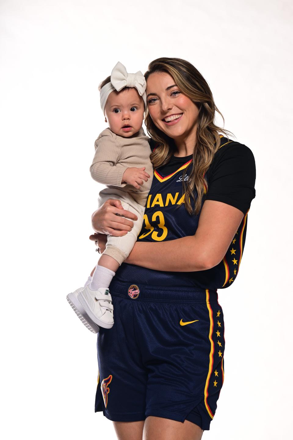 Katie Lou Samuelson poses for a photo with her daughter, Aliya, at Indiana Fever Media Day on May 1, 2024.