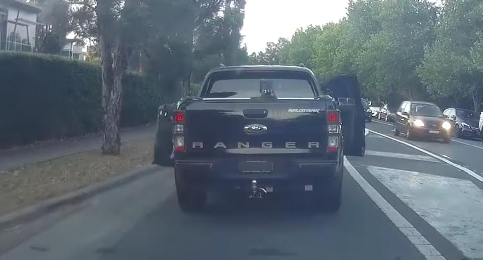 The dog is shown to the left of the car hanging by its neck. Source: Facebook/Dash Cam Owners Australia