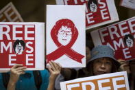 Protesters hold up placards to demand the release of Singaporean teenager Amos Yee outside the Singapore Consulate in Hong Kong, China July 5, 2015. REUTERS/Tyrone Siu