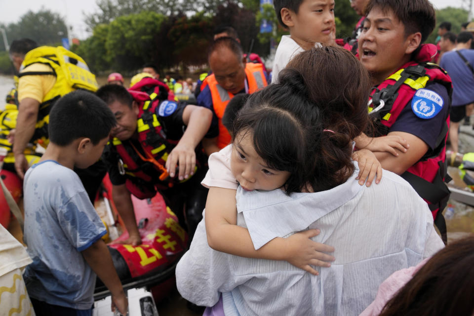 Rescuers help trapped residents evacuate on rubber boats through floodwaters in Zhuozhou in northern China's Hebei province, south of Beijing, Wednesday, Aug. 2, 2023. China's capital has recorded its heaviest rainfall in at least 140 years over the past few days. Among the hardest hit areas is Zhuozhou, a small city that borders Beijing's southwest. (AP Photo/Andy Wong)