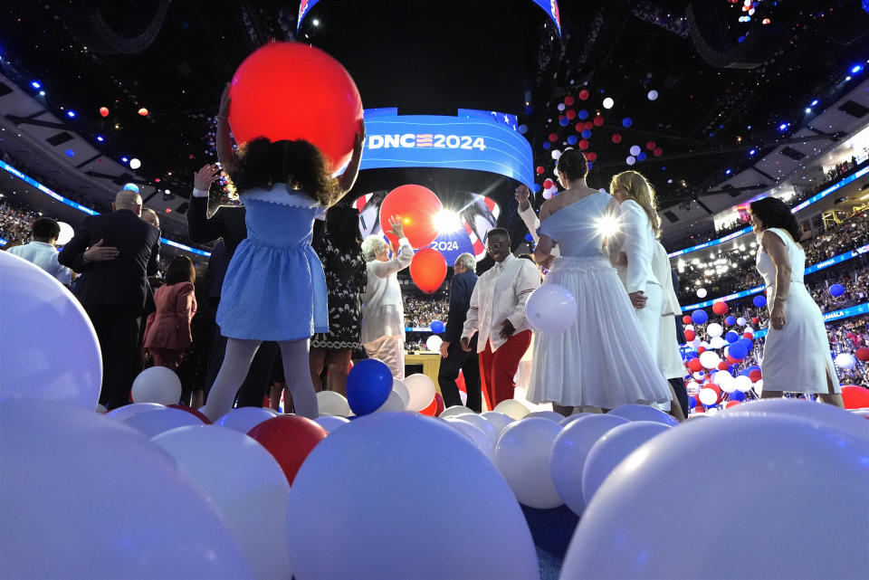 Democratic presidential nominee Vice President Kamala Harris, second gentleman Doug Emhoff, Democratic vice presidential candidate Minnesota Gov. Tim Walz and his wife Gwen Walz and members of their families stand on stage as balloons drop on the final night of the Democratic National Convention in Chicago, Thursday, Aug. 22, 2024. (Kent Nishimura/The New York Times via AP, Pool)