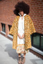 <p>A guest poses outside the Lanyu show wearing a floral jacket and a white dress. <em>[Photo: Getty]</em> </p>