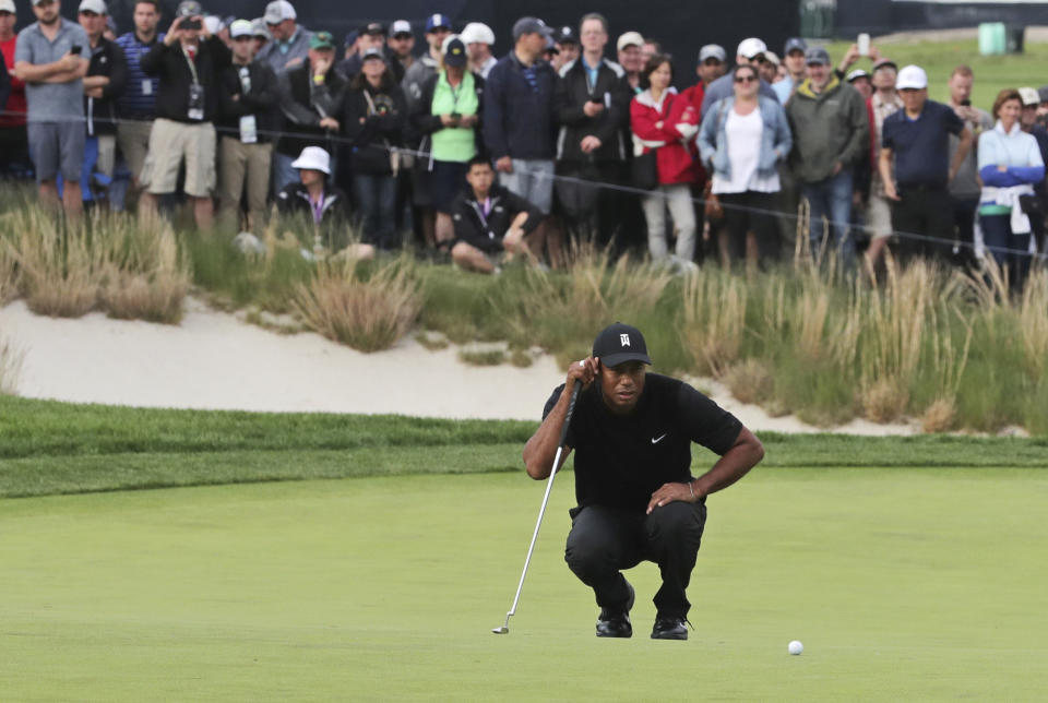Tiger Woods lines up a putt on the 17th green during the second round of the PGA Championship golf tournament, Friday, May 17, 2019, at Bethpage Black in Farmingdale, N.Y. (AP Photo/Charles Krupa)