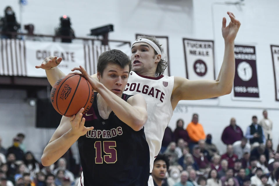 Lafayette center Justin Vander Baan, left, grabs a rebound in front of Colgate forward Keegan Records during the first half of an NCAA college basketball game for the Patriot League tournament championship in Hamilton, N.Y., Wednesday, March 8, 2023. (AP Photo/Adrian Kraus)