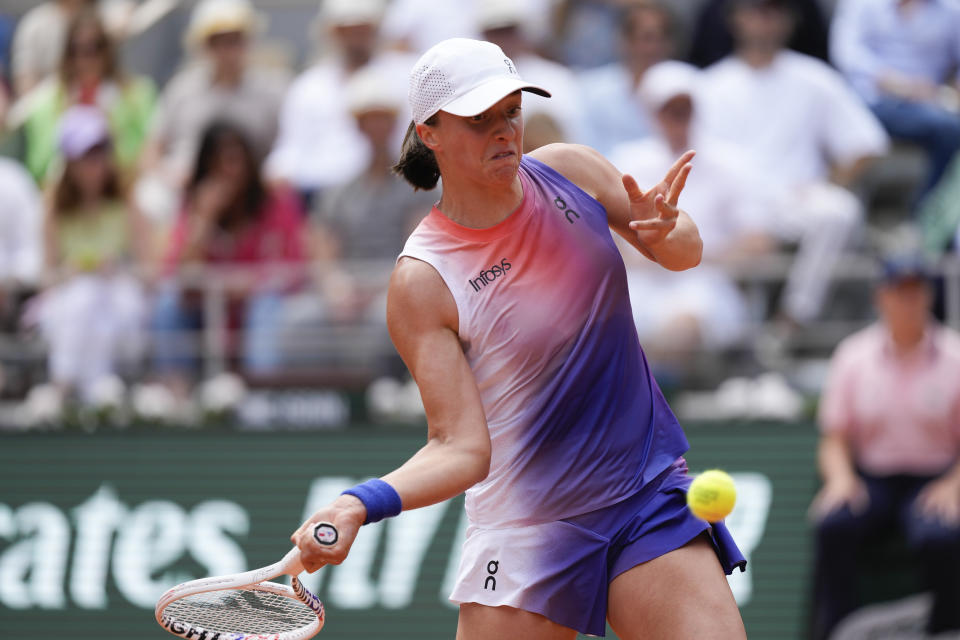 Poland's Iga Swiatek plays a shot against Italy's Jasmine Paolini during the women's final of the French Open tennis tournament at the Roland Garros stadium in Paris, France, Saturday, June 8, 2024. (AP Photo/Thibault Camus)