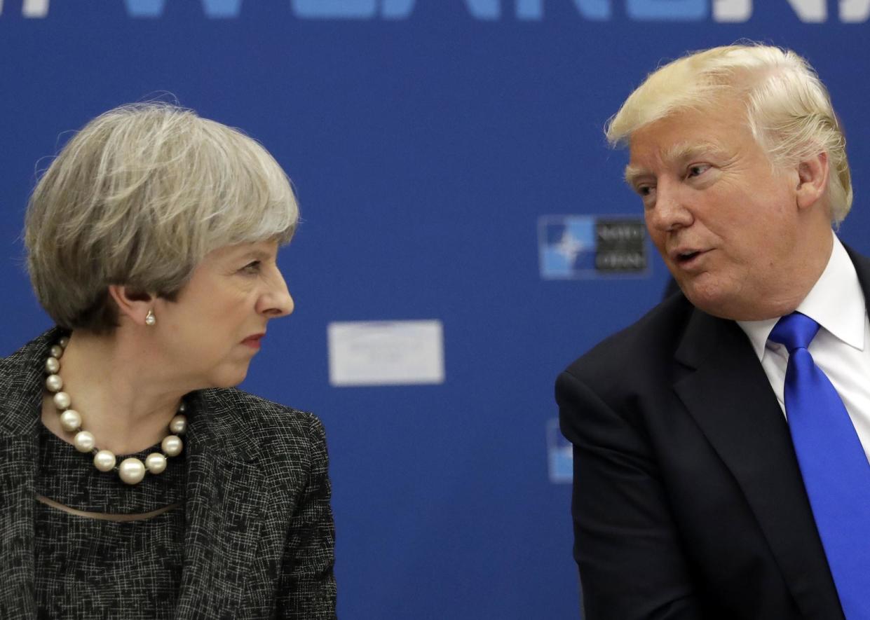 President Donald Trump speaks to British Prime Minister Theresa May during in a working dinner meeting at the NATO headquarters: AP