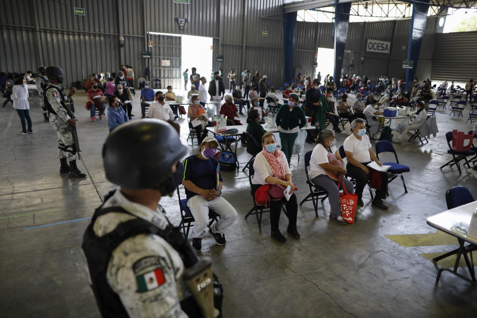 Residents over age 60 wait to be vaccinated with the Russian COVID-19 vaccine Sputnik V at the Palacio de los Deportes, in the Iztacalco borough of Mexico City, Wednesday, Feb. 24, 2021. (AP Photo/Rebecca Blackwell)