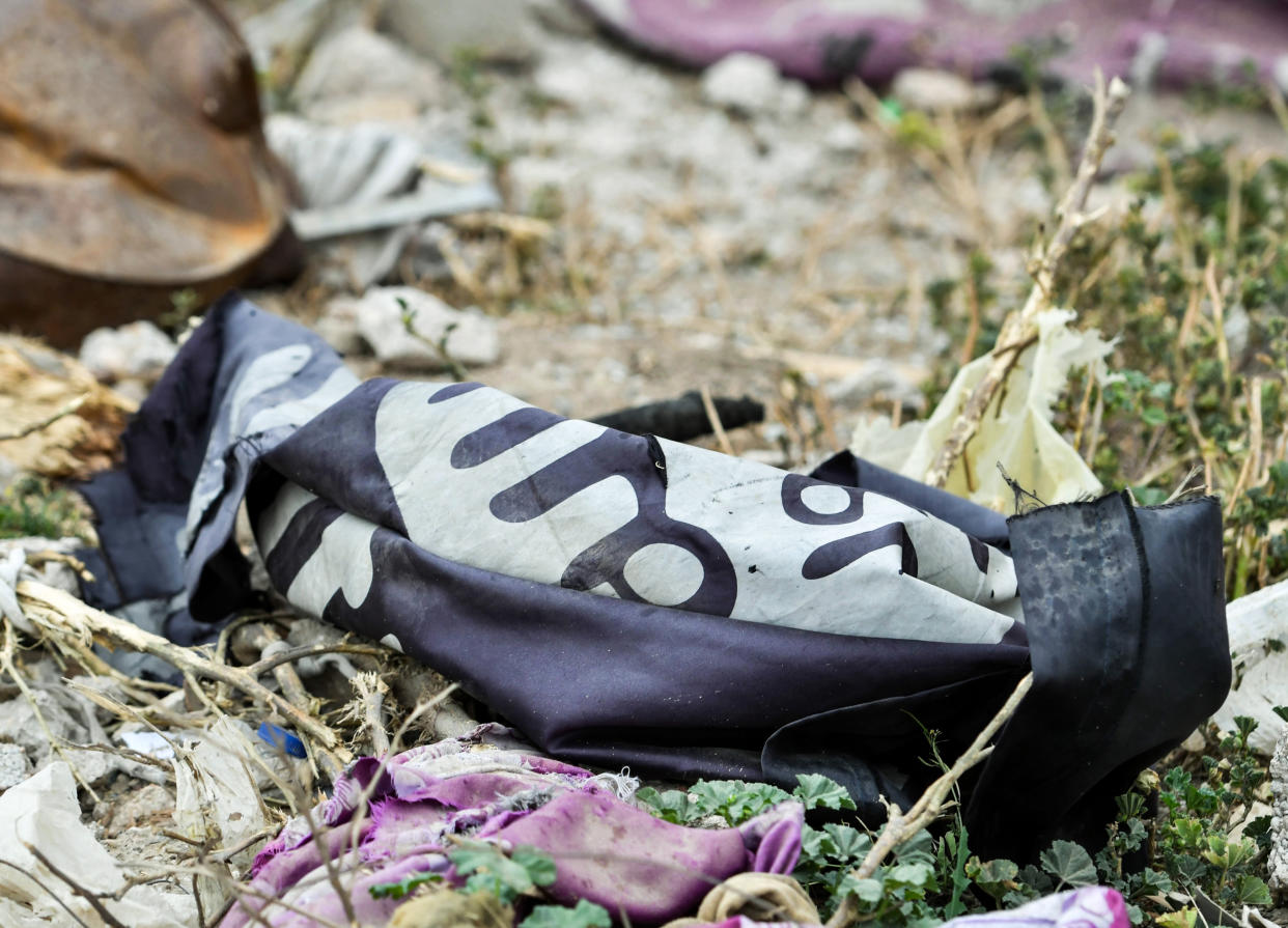 This picture taken on March 24, 2019 shows a discarded Isis group flag lying on the ground in the village of Baghouz in Syria’s eastern Deir Ezzor province near the Iraqi border, a day after IS group’s ‘caliphate’ was declared defeated by the US-backed Kurdish-led Syrian Democratic Forces (Picture: AFP/Getty)