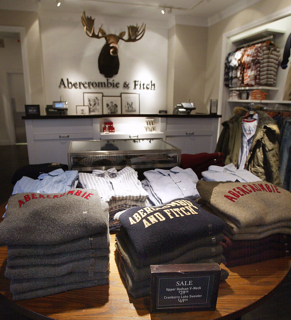 a table in the store with neatly folded sweaters a shirts