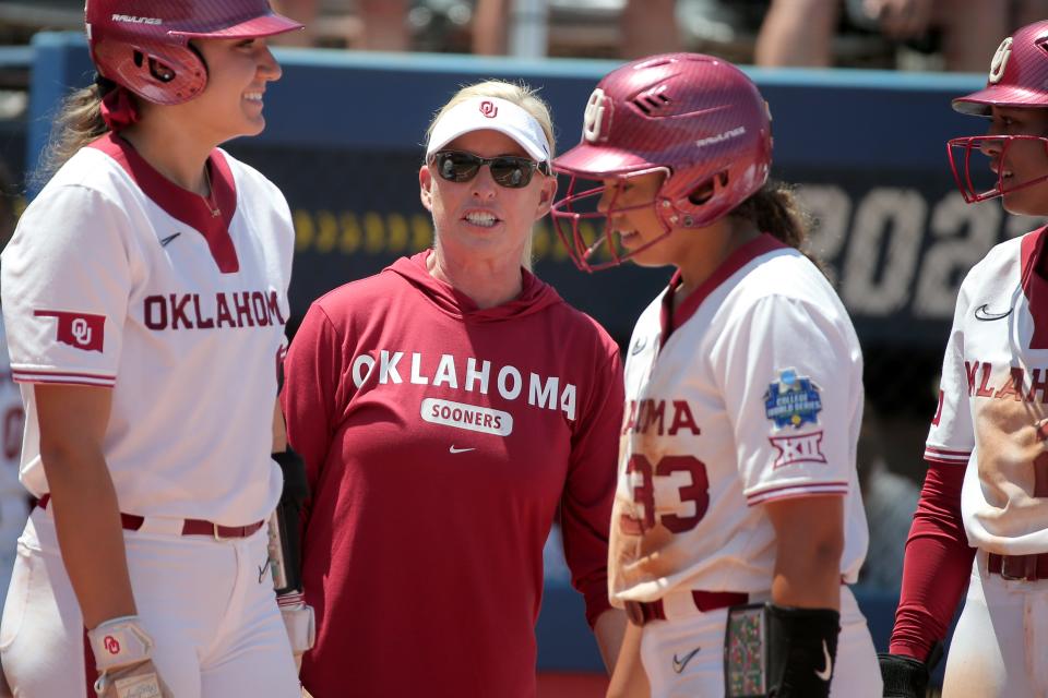 Oklahoma coach Patty Gasso talks with Oklahoma’s Kinzie Hansen (9) and Alyssa Brito (33) during a softball game between the University of Oklahoma Sooners (OU) and <a class="link " href="https://sports.yahoo.com/ncaaf/teams/tennessee/" data-i13n="sec:content-canvas;subsec:anchor_text;elm:context_link" data-ylk="slk:Tennessee;sec:content-canvas;subsec:anchor_text;elm:context_link;itc:0">Tennessee</a> in the Women’s College World Series at USA Softball Hall of Fame Stadium in Oklahoma City, Saturday, June 3, 2023.