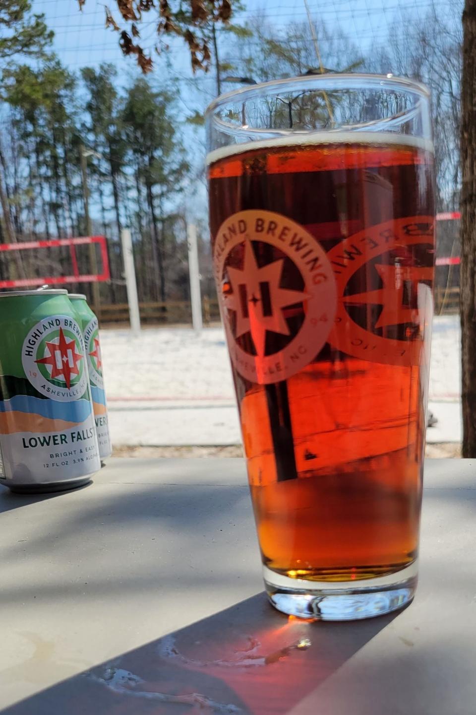 The viewing area at the volleyball courts consists of picnic tables as well as lounge chairs, where visitors can enjoy their favorite Highland Brewing brews.