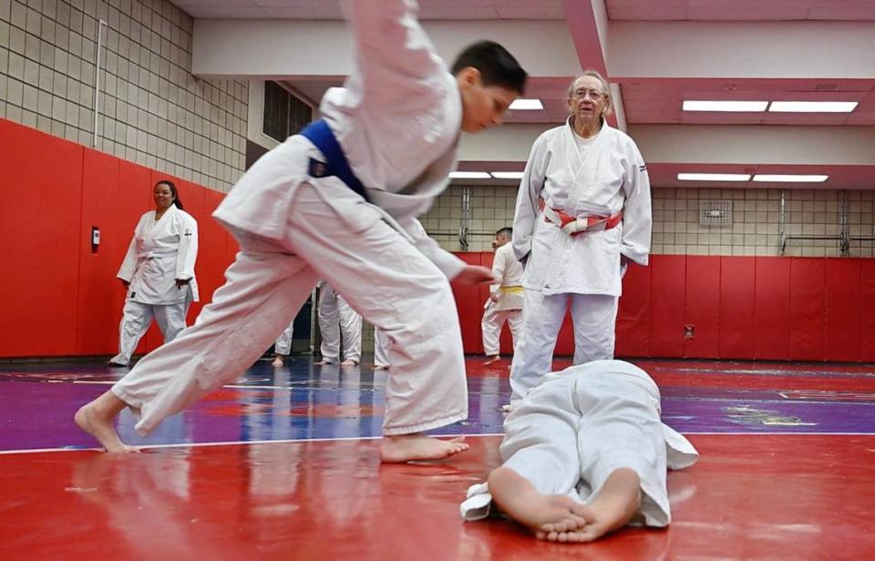 Eighty-three year old Myra Kirk-Goode, background, a 7th degree black belt, watches as her students run through drills during her judo class Wednesday, April 17, 2024 in Clovis