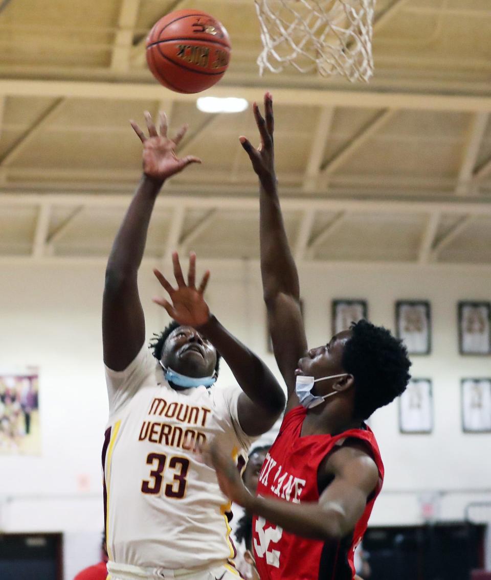 Mount Vernon's Manny Barkor (33) goes up for a shot in front of Fox Lane's Dylan Watson (32) during boys basketball action at Mount Vernon High School Jan. 14, 2022. 