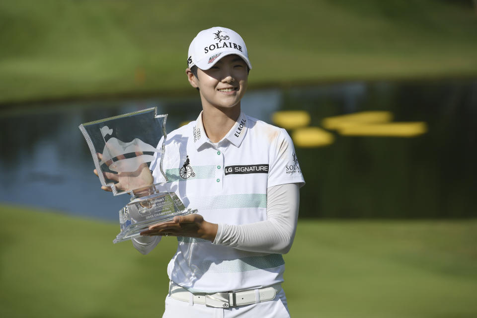 FILE - In this June 30, 2019, file photo, Sung Hyun Park holds up the trophy after winning the LPGA Walmart NW Arkansas Championship golf tournament in Rogers, Ark. Jin Young Ko and Sung Hyun Park were Nos. 1 and 2 in the women's world golf ranking when they left Florida on Nov. 24 after the LPGA Tour season finale. They skipped the opening two events in Florida and two others in Australia and planned to return to competition during the Asia swing. That's when the spread of COVID-19 halted sports. (AP Photo/Michael Woods, File)