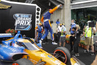 Race driver Scott Dixon, of New Zealand, jumps off his car after winning the IndyCar auto race at Indianapolis Motor Speedway in Indianapolis, Saturday, July 4, 2020. (AP Photo/Darron Cummings)